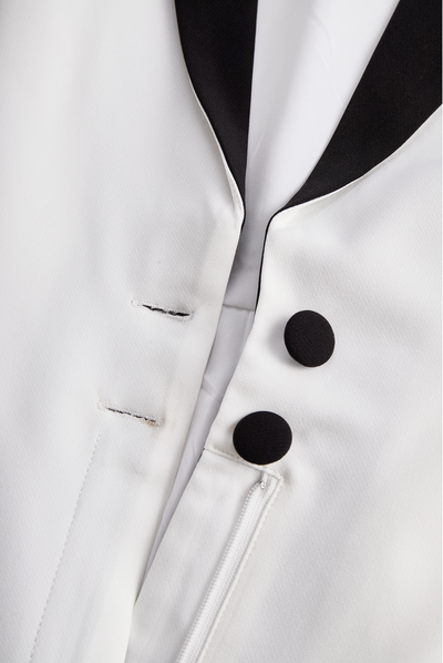 Sleek White Jumpsuit With Dual Button Detail And Black Lapel